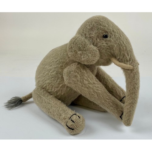 3037 - An early 20th century burlap plush jointed elephant, probably Steiff, boot button eyes, 15.5cm high,... 