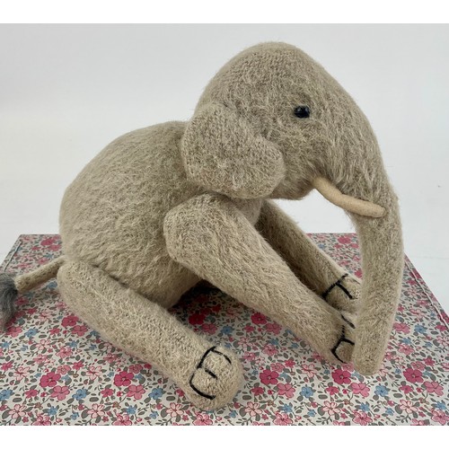3037 - An early 20th century burlap plush jointed elephant, probably Steiff, boot button eyes, 15.5cm high,... 