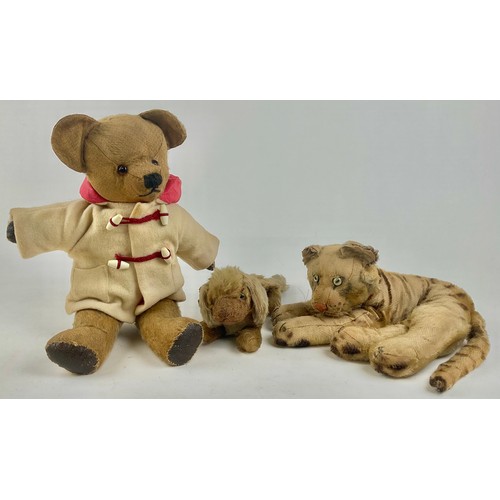 3050 - An early 20th century Steiff mohair plush lying tiger, with green cats eyes, stitched nose and paws,... 