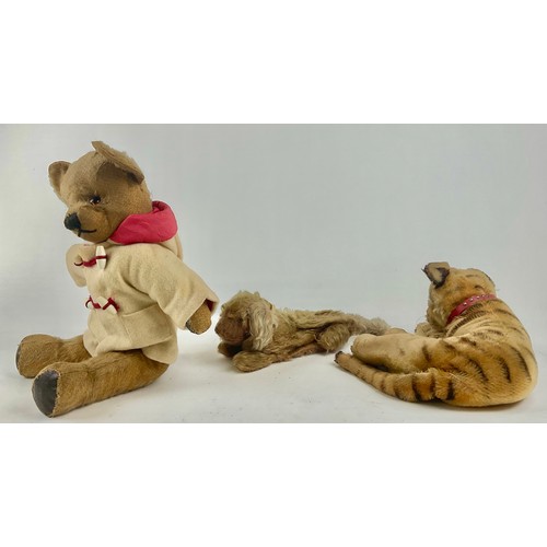 3050 - An early 20th century Steiff mohair plush lying tiger, with green cats eyes, stitched nose and paws,... 