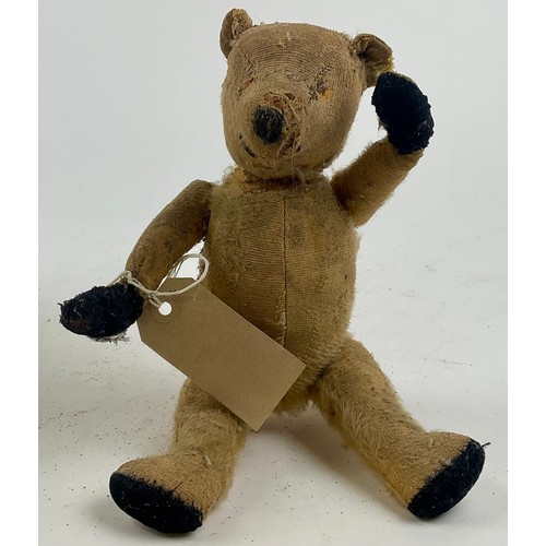3051 - A well-loved early 20th century blonde mohair jointed bear, straw filled, slightly humped back, stit... 