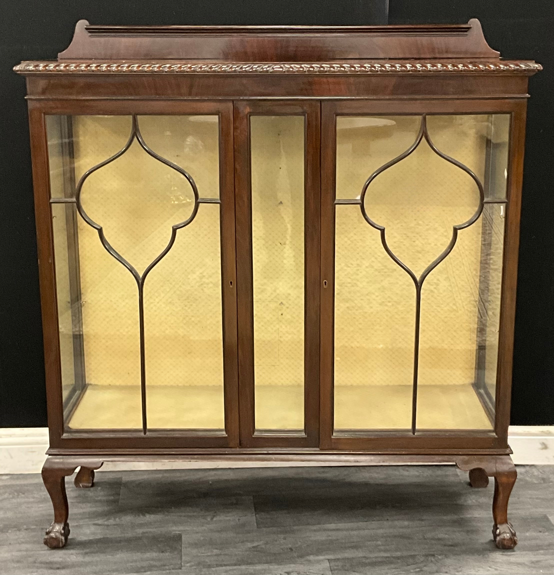A late Victorian flame mahogany display cabinet, rope twist moulded top ...