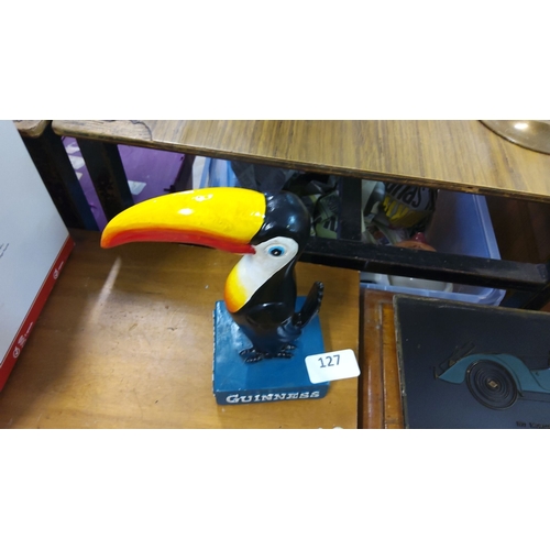 127 - Hand-painted toucan statue on a blue base labeled 