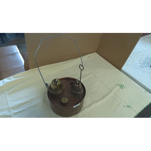 15 - Copper oil lamp with dual brass burners and a metal carrying handle.