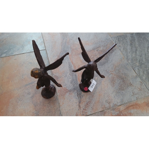 161 - Pair of cast iron fairy figurines with a rustic finish. Each fairy stands with outstretched wings an... 