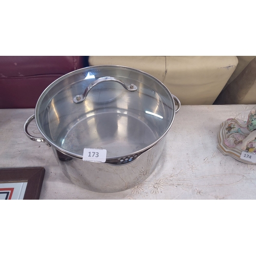 173 - Stainless steel pot with glass lid, featuring sturdy handles and a polished finish.