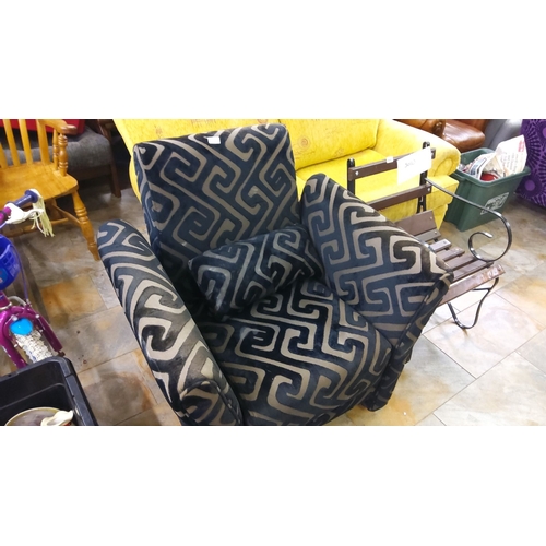 186 - Plush upholstered armchair with black and grey geometric pattern, complete with matching cushion.