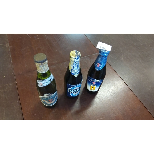 209 - Set of three vintage beer bottles: Tuborg Fine Festival, Harp Lager, and Tennent's Lager.