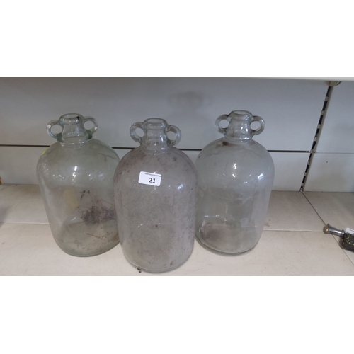 21 - Three vintage clear glass demijohns with double handle necks.