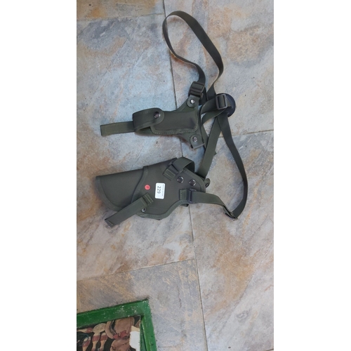 229 - Green tactical shoulder holster with adjustable straps and snap closures.