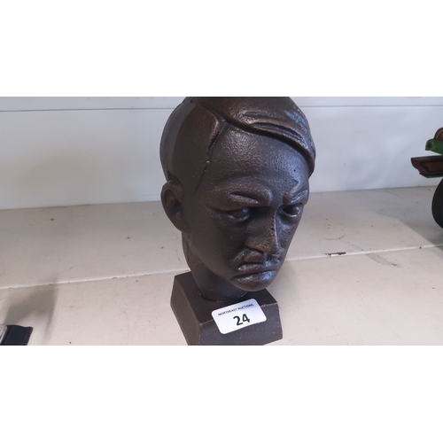 24 - Cast iron bust depicting a stern-faced Hitler, mounted on a square base, offering significant weight... 