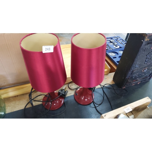 243 - Pair of modern red table lamps with matching red shades and black power cords.