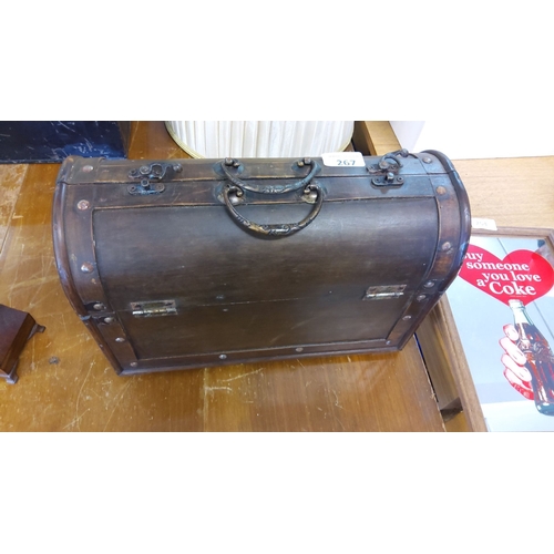 267 - Antique wooden chest with metal hardware, dark polished finish, with a curved lid and decorative han... 