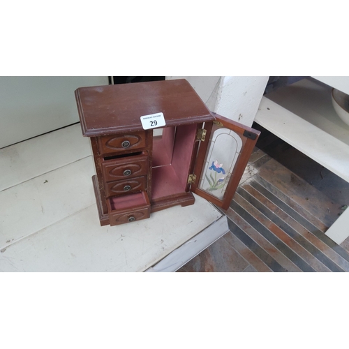 29 - Wooden jewelry cabinet with stained glass floral detail on the door. The cabinet features three smal... 