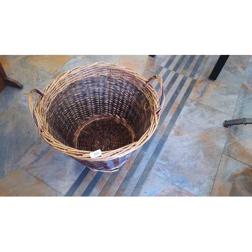 312 - Hand-woven wicker basket with integrated handles. Natural brown tones. Approximate dimensions: 18” d... 