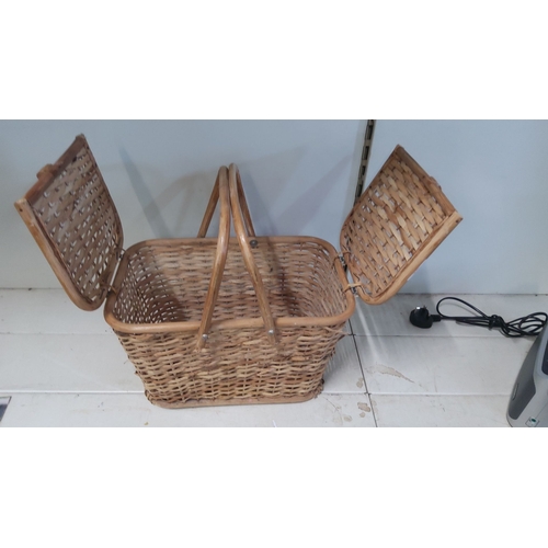 32 - Vintage woven wicker picnic basket with dual-hinged lids and center carrying handles.