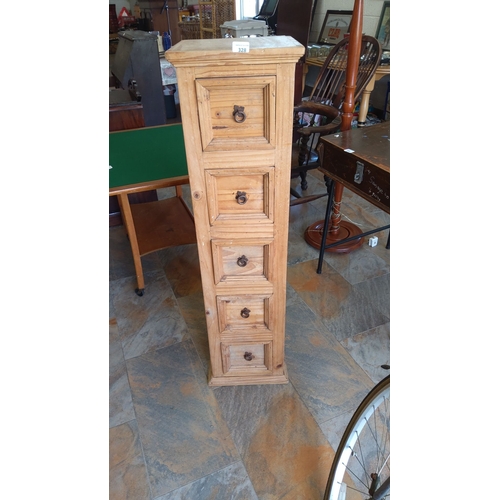 328 - Tall wooden chest with five drawers, featuring rustic ring pulls. The chest is crafted from a light-... 