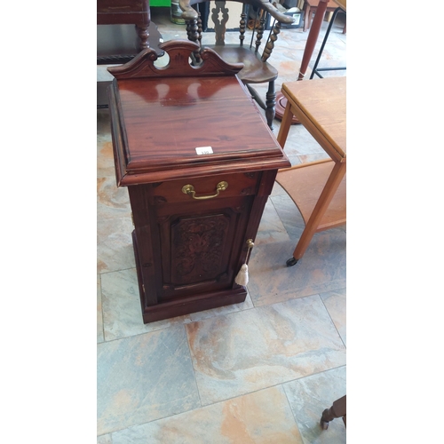 330 - Mahogany side cabinet with ornaby ate carved door and brass handle, featuring a decorative pediment ... 