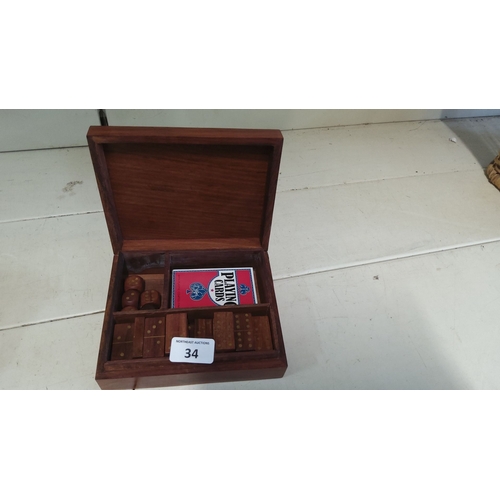 34 - Wooden box containing dominoes, dice, and a deck of playing cards.