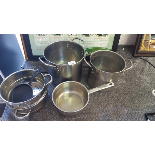 345 - Set of stainless steel pots and pans. Includes three stock pots and one saucepan. Comes with a steam... 