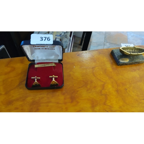 376 - Vintage Diamond Cut gold-tone cufflinks and tie clip set, made in England, in original case.