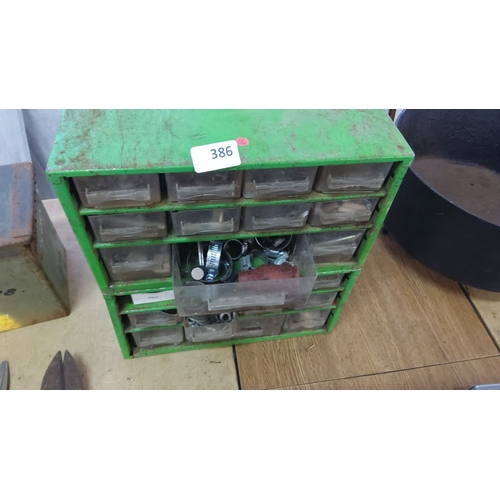 386 - Green metal storage cabinet with 21 clear plastic drawers with contents