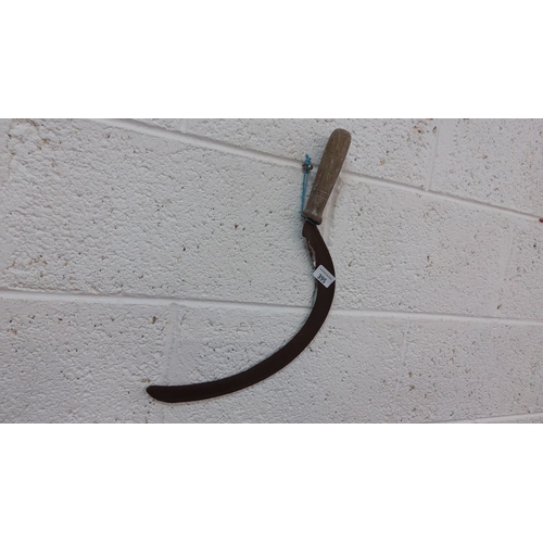 395 - Vintage sickle with a wooden handle, curved metal blade, and a hanging cord.