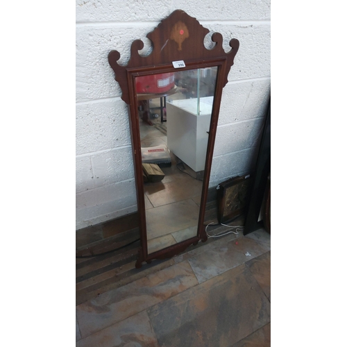 396 - Mahogany framed mirror with scrollwork crest. Likely from the early to mid-20th century. Classic des... 