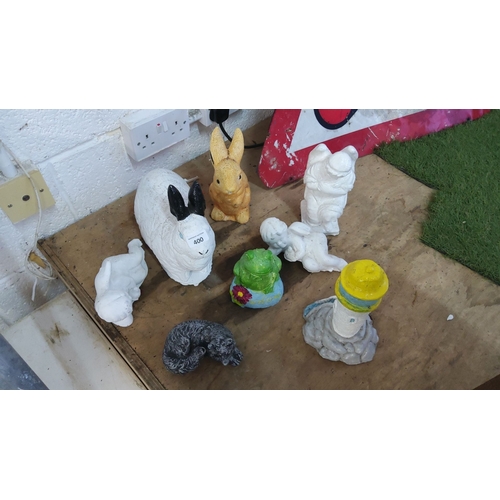 400 - Set of eight decorative concrete garden figures. Includes various animal and lighthouse sculptures. ... 