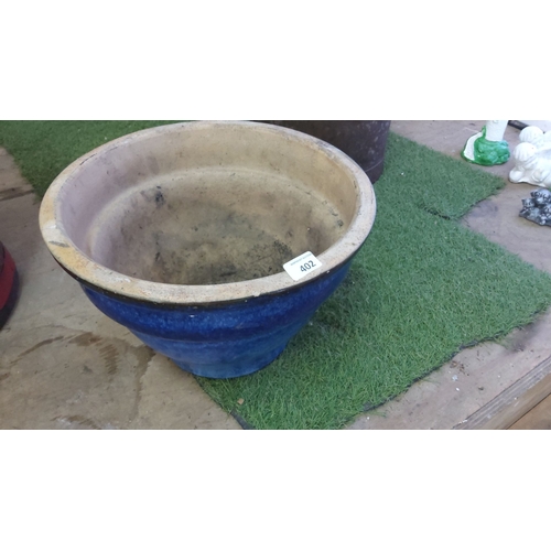 402 - Large blue and beige ceramic planter with a flared rim.