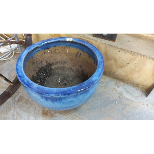 411 - Large ceramic planter in vibrant blue glaze. Diameter approximately 18 inches. Classic round shape.