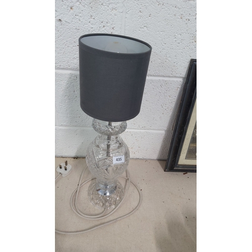 435 - Clear crystal table lamp with black lampshade. Features an intricate cut pattern and a vintage desig... 