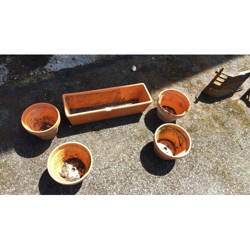 447 - Set of five orange ceramic flower pots, including four round pots and one rectangular planter.