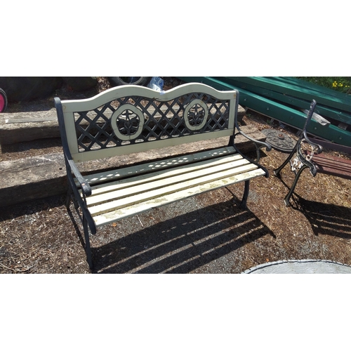 454 - Outdoor cast iron and wood garden bench with lattice and floral backrest design.