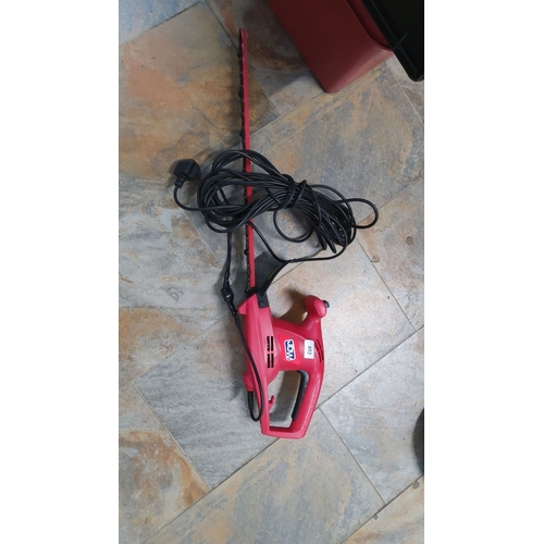 492 - WDW electric hedge trimmer in red with black cord.