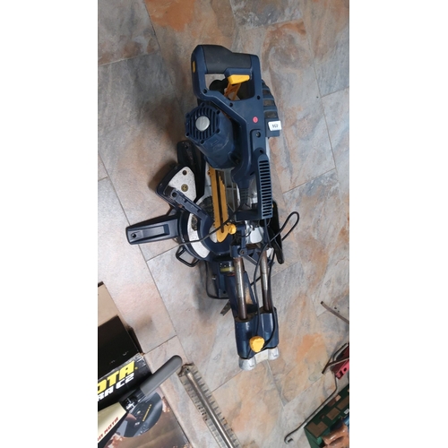 494 - Ryobi Compound Miter Saw, blue and yellow. Features adjustable cutting angles and laser guide.