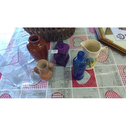 511 - Assorted vintage collectible glass and ceramic vessels. The collection includes a purple twisted bot... 