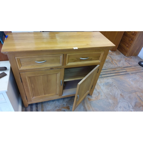 85 - This is a wooden sideboard featuring two drawers and two cabinet doors, fitted with modern metal han... 