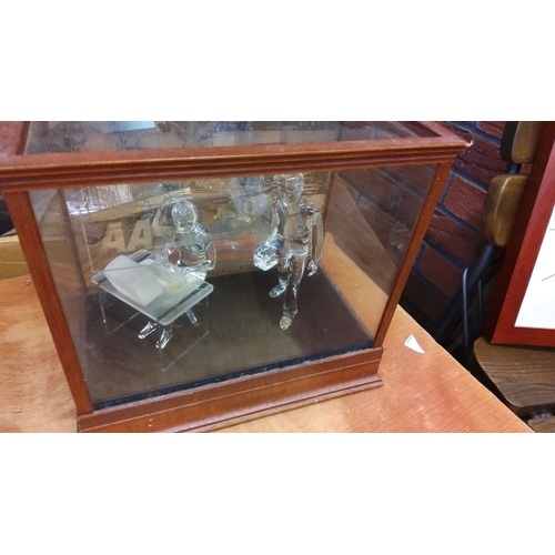 91 - Wooden display case with glass figurines. The case is crafted from wood with beveled edges and trans... 