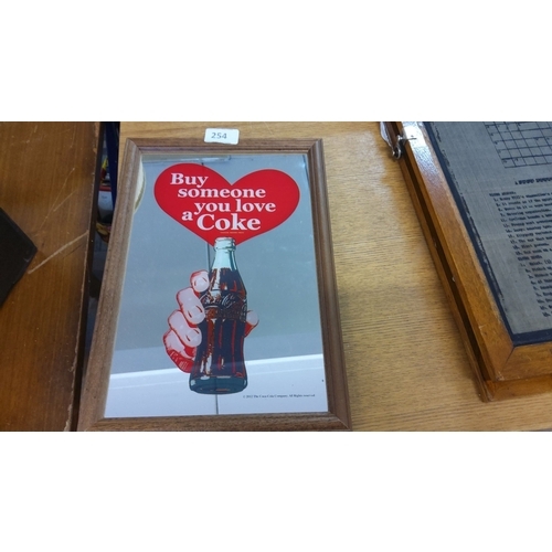 254 - 2011 Coca-Cola promotional mirror plaque framed in wood. Features a vintage-style hand holding a Cok... 