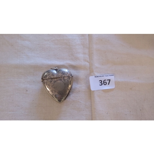 367 - Heart-shaped sterling silver vesta case with ornate floral engravings. This piece features a hinged ... 