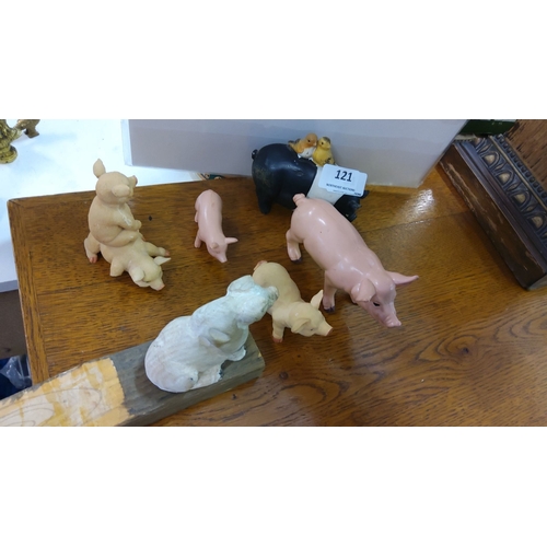 121 - A charming set of six pig-themed figurines, featuring various poses and materials.