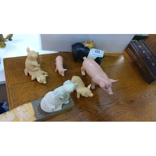 121 - A charming set of six pig-themed figurines, featuring various poses and materials.