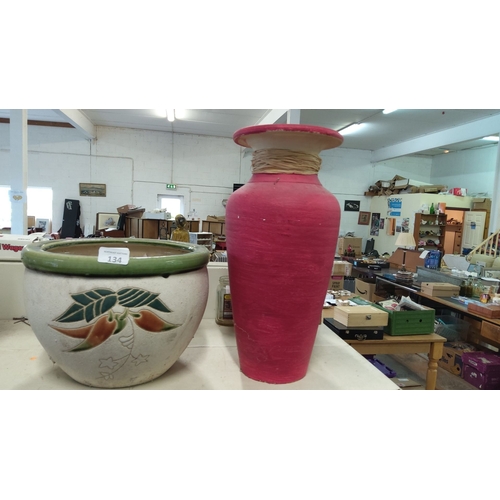 134 - Pair of decorative planters: one round, white with green rim and floral motif; one tall, pink with w... 