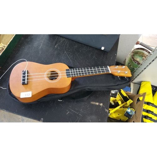 152 - Vintage VUK15 ukulele, featuring a natural wood finish with a compact design, supported by white nyl... 