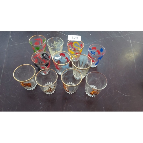 179 - Set of 10 vintage shot glasses with gold rims, diverse colored patterns including roosters, clowns, ... 