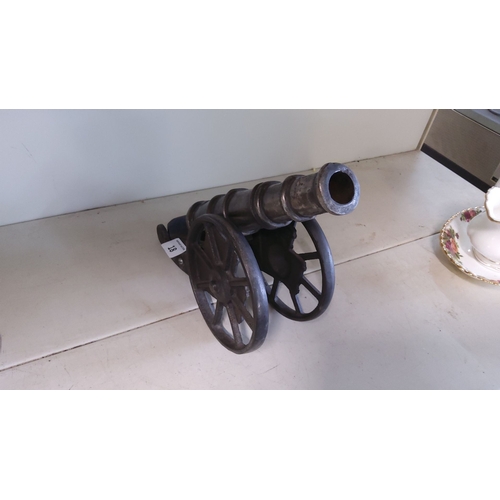 18 - Vintage cast iron model cannon with rolling wheels, detailed craftsmanship.