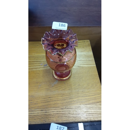 186 - Victorian cranberry glass vase with ruffled rim and hand-painted floral design, enhanced with gold d... 