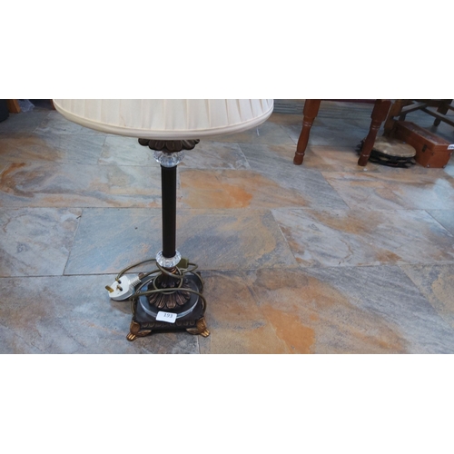 193 - Antique table lamp with a pleated fabric shade. The lamp features an ornate bronze base with claw fe... 