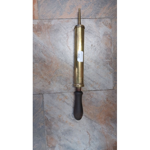 200 - Vintage brass pump with wooden handle. This hand-operated device features a cylindrical brass body a... 